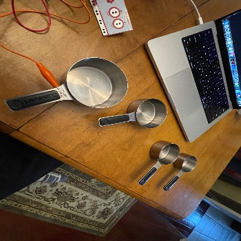 I used measuring cups that were metal as a conductive material and would connect each aligator clip to the cup. I then used this with my sketch from earlier where on click particles would appear. I modified the particles so that on click the colour would change along with the number.